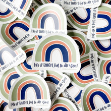 Load image into Gallery viewer, Dark blue text "Life is tough, but so are you!" under a four stripe rainbow. The inner stripe is thin and light pink, the next stripe is thick and dark blue, the third stripe is slightly less thick and salmon colored, and the last stripe is thicker and green. The sticker is in front of a pile of the same sticker.
