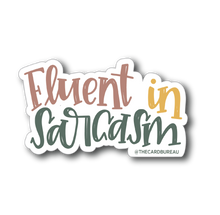 Load image into Gallery viewer, A sticker with text "Fluent in Sarcasm". "Fluent" is red, "in" is yellow, and "sarcasm" is dark green. The background color is white.