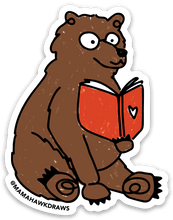 Load image into Gallery viewer, Sticker of a brown bear reading a red book with a heart on it.