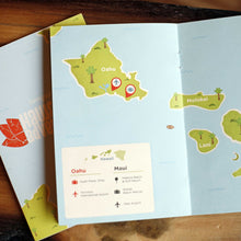 Load image into Gallery viewer, Living social hawaii book laying on table open to a page of a map with a legend