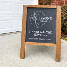 Load image into Gallery viewer, Hand drawn logo for Beyond the Stars on a small stand up easel. Below the crescent moon logo, it says "handcrafted jewelry" and social media information. The chalkboard background is black and all the lettering and illustrations are in white.