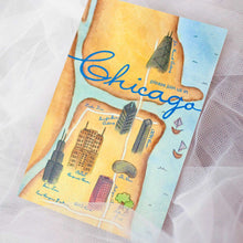Load image into Gallery viewer, Multi-colored card with map design of water and buildings with text "Chicago" and white lace in the background