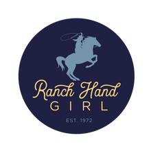 Load image into Gallery viewer, Navy blue circle logo with text &quot;ranch hand girl&quot; in yellow. &quot;Ranch Hand&quot; is in script lettering, and &quot;girl&quot; is in a rounded san serif font kerned out. Below the yellow type is &quot;EST. 1972&quot; in a smaller, light blue san serif font. Above all the type is a lighter blue horse on the back two hind legs with a female holding a lasso.
