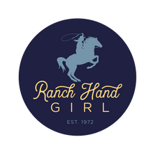 Load image into Gallery viewer, Navy blue circle logo with text "ranch hand girl" in yellow. "Ranch Hand" is in script lettering, and "girl" is in a rounded san serif font kerned out. Below the yellow type is "EST. 1972" in a smaller, light blue san serif font. Above all the type is a lighter blue horse on the back two hind legs with a female holding a lasso.