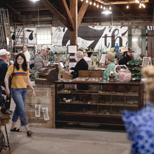 Load image into Gallery viewer, Further view of 7th street salvage's mural on a white wall with black sevens and "th" in a collage style