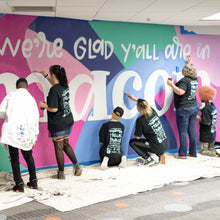 Load image into Gallery viewer, Shot of six people painting different parts of the macon airport mural