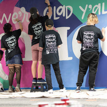 Load image into Gallery viewer, Shot of four people painting different parts of the macon airport mural