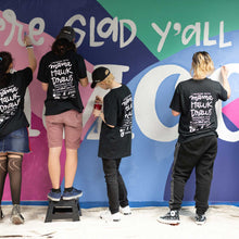 Load image into Gallery viewer, Shot of four people painting different parts of the macon airport mural