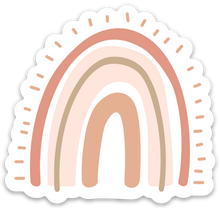 Load image into Gallery viewer, rainbow shaped sticker with pink tones with trees in the background