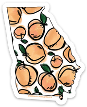 Load image into Gallery viewer, State of Georgia shaped sticker with peach design within the borders. The background is a collage of the same sticker.