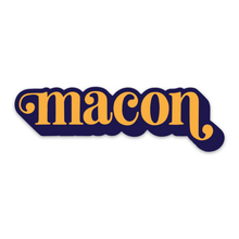 Load image into Gallery viewer, Sticker says "Macon" in orange in lower case serif font with ball flourishes on the "m" and the descender of the "n." The word has a angled drop shadow in navy