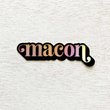 Load image into Gallery viewer, Black bordered, holographic "macon" sticker on white wooden background.
