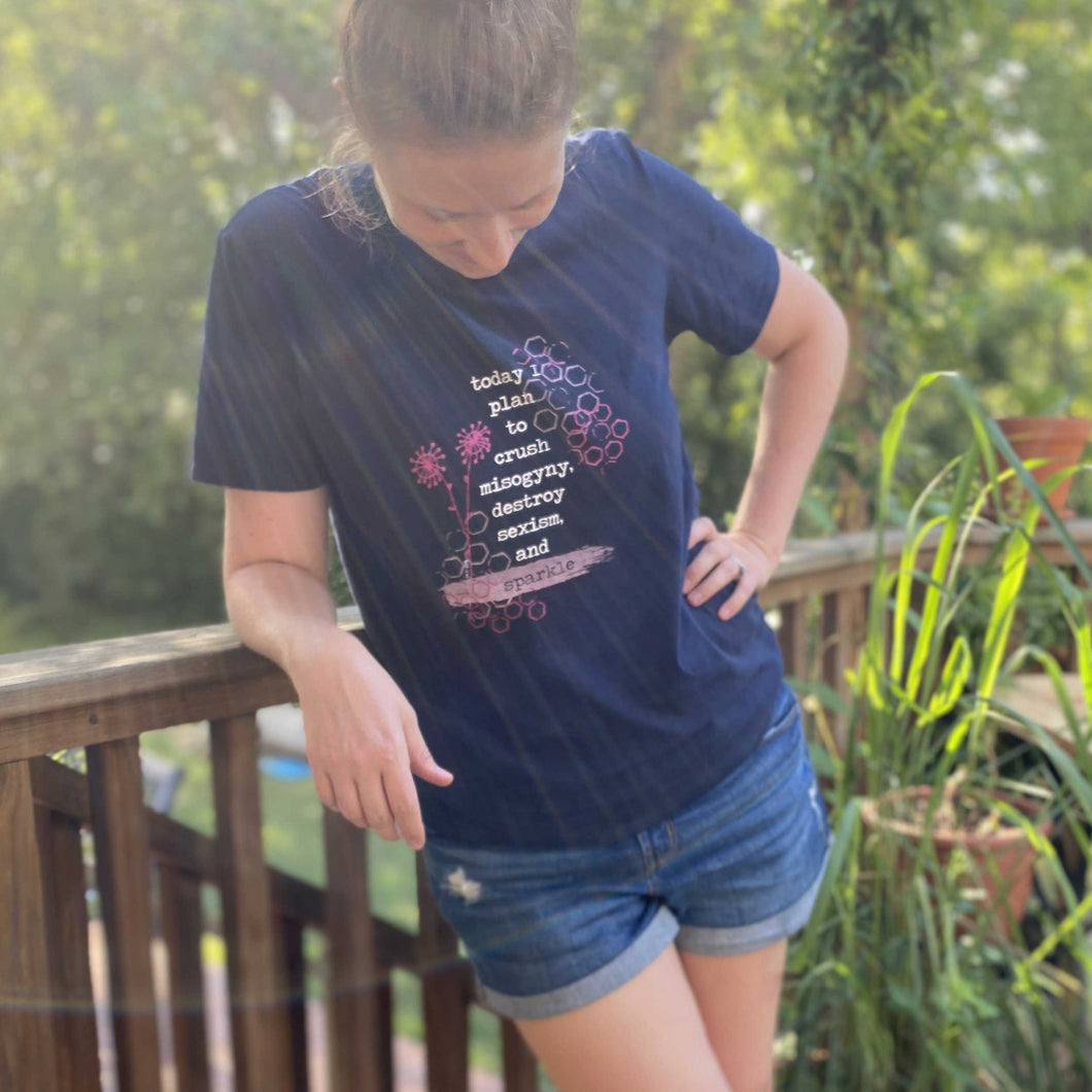 Erin, aka Mama Hawk Draws, wears the navy blue t-shirt she designed for A Girl Like Me's clothing line. The quote on the tee says 