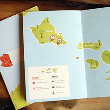 Load image into Gallery viewer, Living social hawaii book laying on table open to a page of a map with a legend
