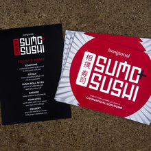 Load image into Gallery viewer, Two living social prints stacked next to eachother on granite background. The left is a menu for &quot;sumo sushi&quot; and the right is an advertisement for &quot;sumo sushi&quot; with a red circle and lines in the background.
