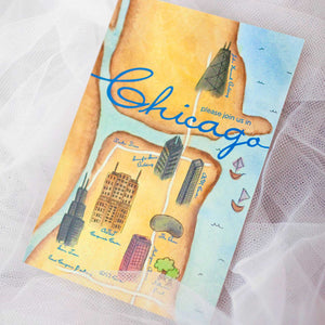 Multi-colored card with map design of water and buildings with text "Chicago"  and white lace in the background