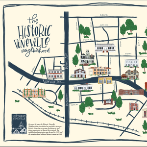 Painted neighborhood map labeled "the historic vineville neighborhood" with black lines and painted buildings and trees.eenery in the background