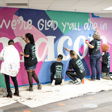 Load image into Gallery viewer, Shot of six people painting different parts of the macon airport mural
