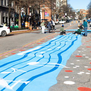 View of vertical road painted with blue and white paint with music notes and dots.