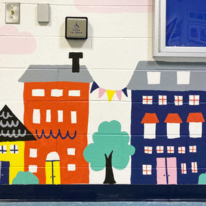 Close up of the building and trees at the bottom of the "habits at home" mural