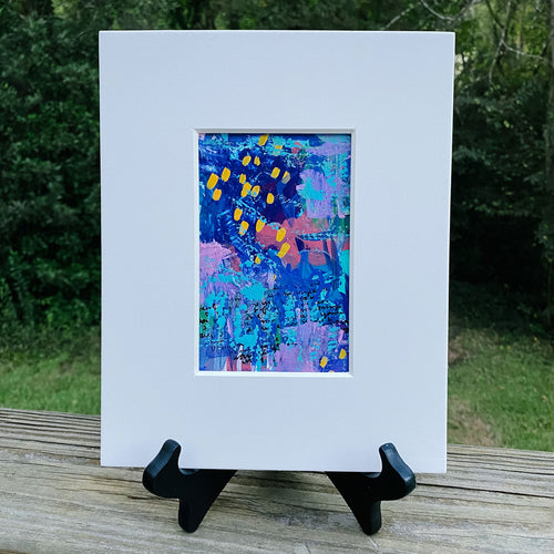 Printed multicolored abstract design inside white print frame.