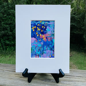 Printed multicolored abstract design inside white print frame.