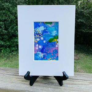 Printed multicolored abstract design inside white print frame.