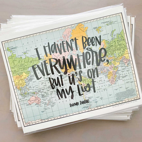 Stack of horizontal multicolored vintage style maps of the world with hand lettered text that says 