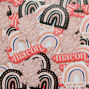 Collage of pink toned stickers with rainbow design and text including "macon" and "you are stronger than you think"